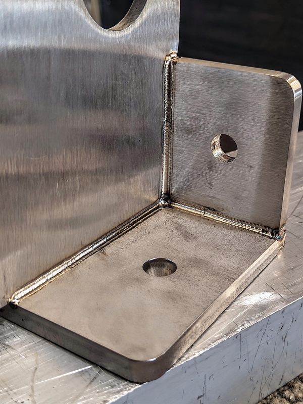 Close-up of welds joining three metal plates